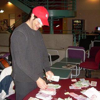 How much? Steve, one of the ANTH 316 students, counts Canadian Tire money; it is being donated to the Haven House Women's Shelter. 